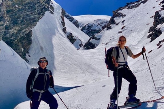 a group of people skiing down a mountain