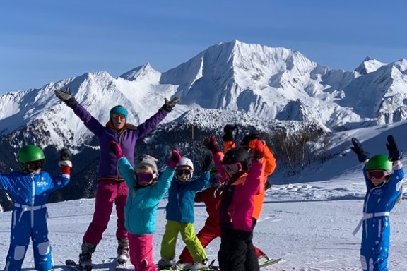 a group of people riding skis on a snowy mountain