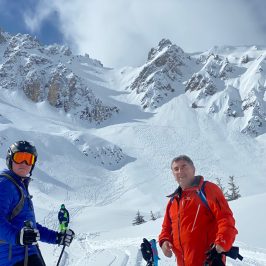 a group of people riding skis on a snowy mountain