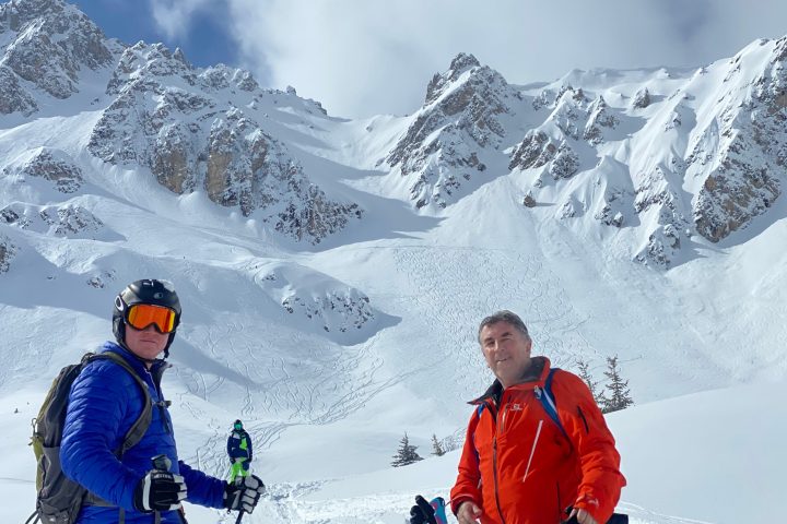 a group of people riding skis on a snowy mountain