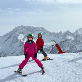 a person riding a snowboard down a snow covered slope