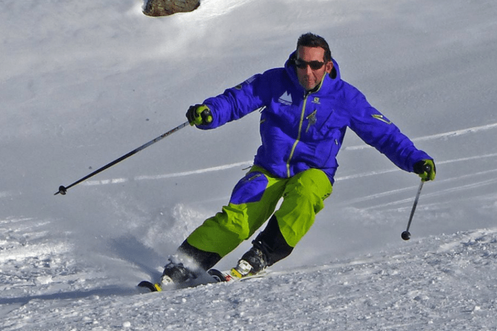 a man skiing down a snow covered slope